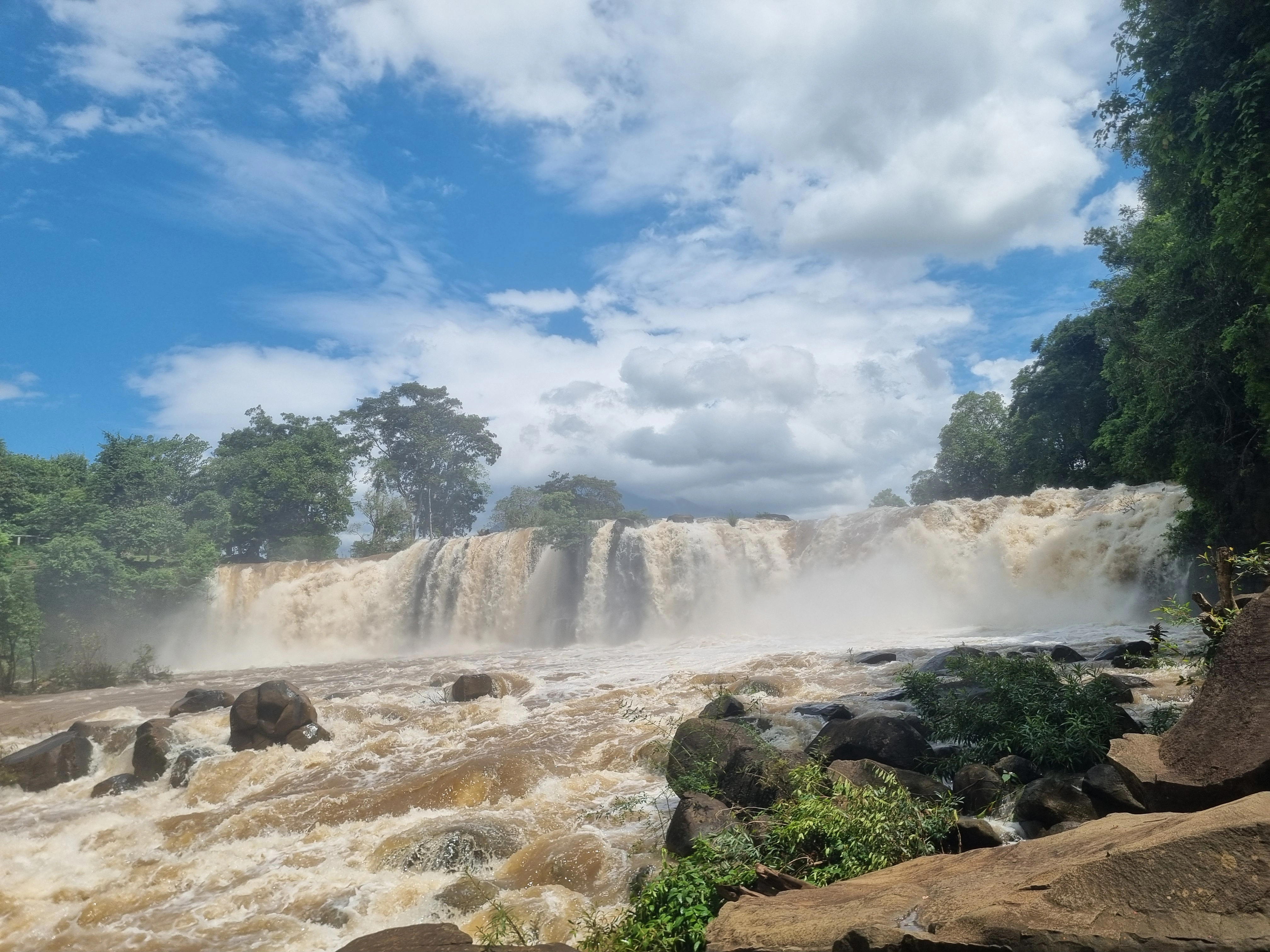 Wide view of Tad Lo Waterfall and the Xe Set River in southern Laos