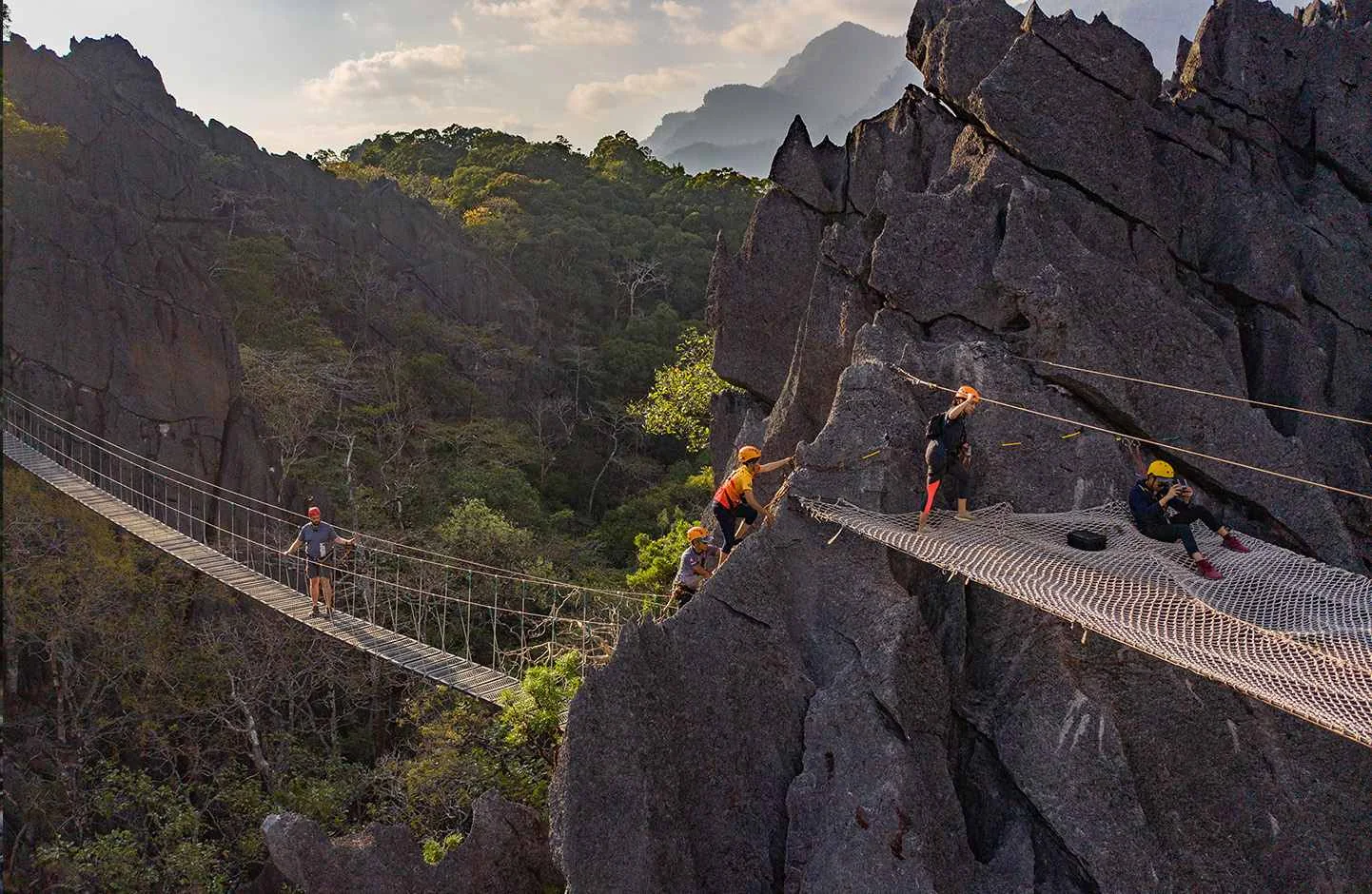 Visitors on an elevated bridge between limestone cliffs at The Rock ViewPoint, Khammouane