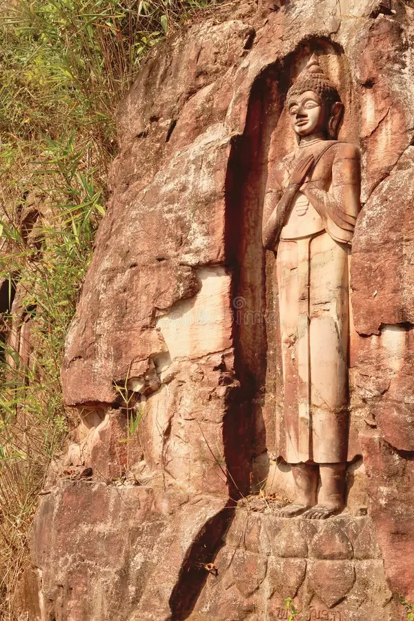 Carved sandstone Buddha beside the Thakhek Loop road